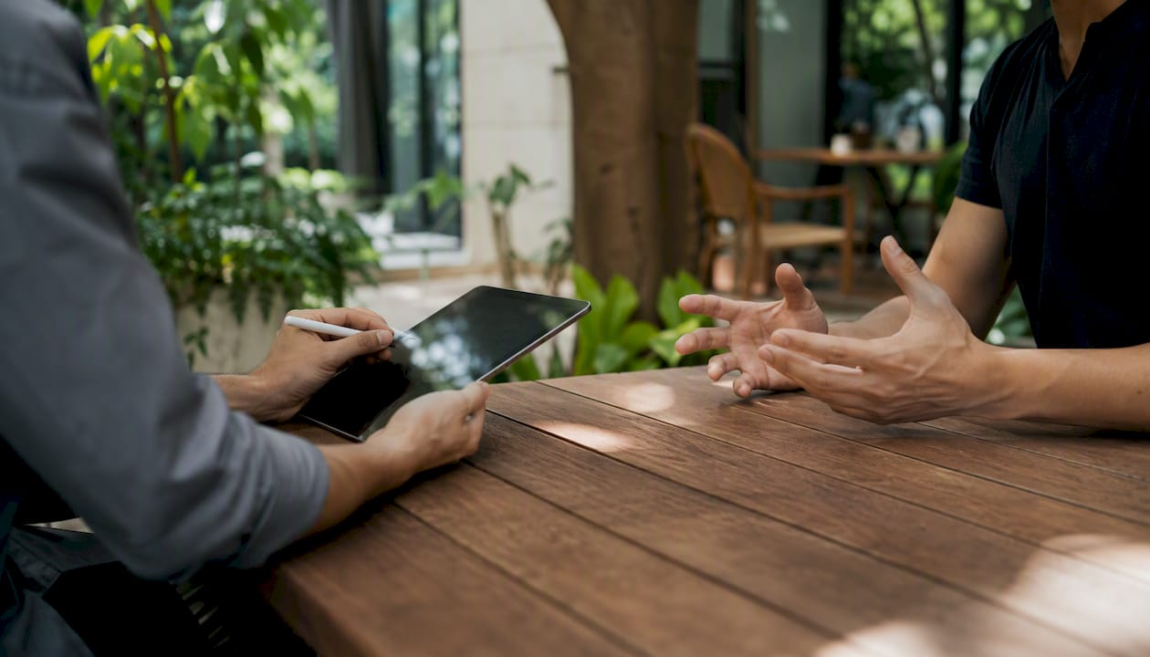 Manager coaching employee with active note-taking
