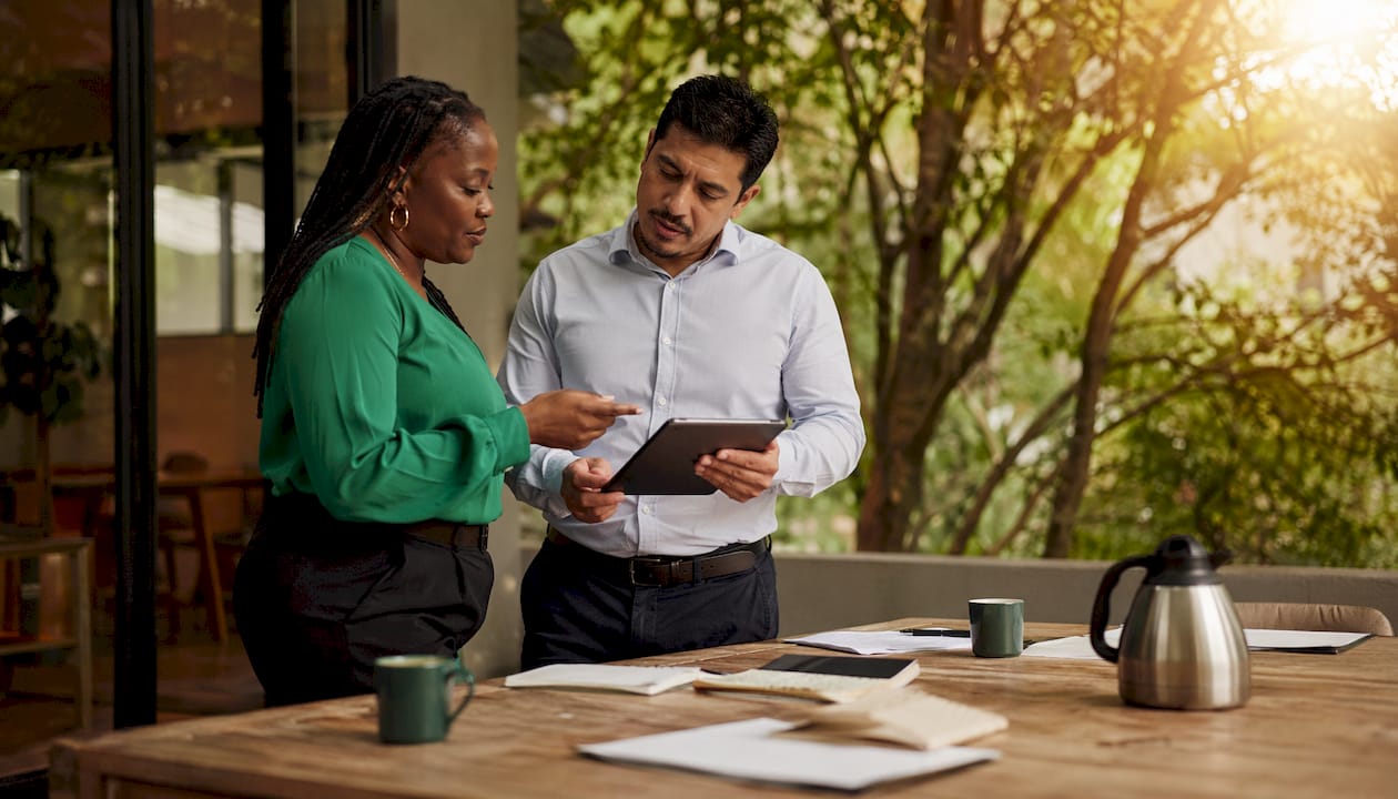 Two professionals discussing AI time tracking tools