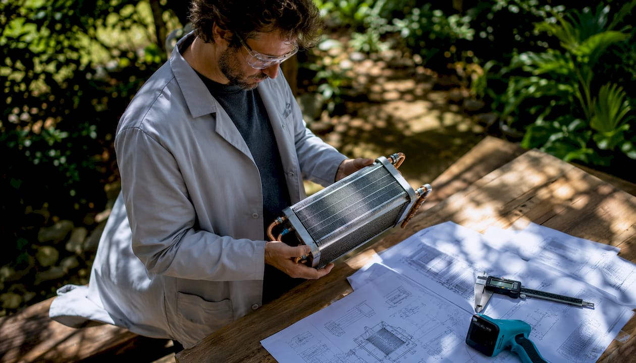 Engineer inspecting heat exchanger prototype