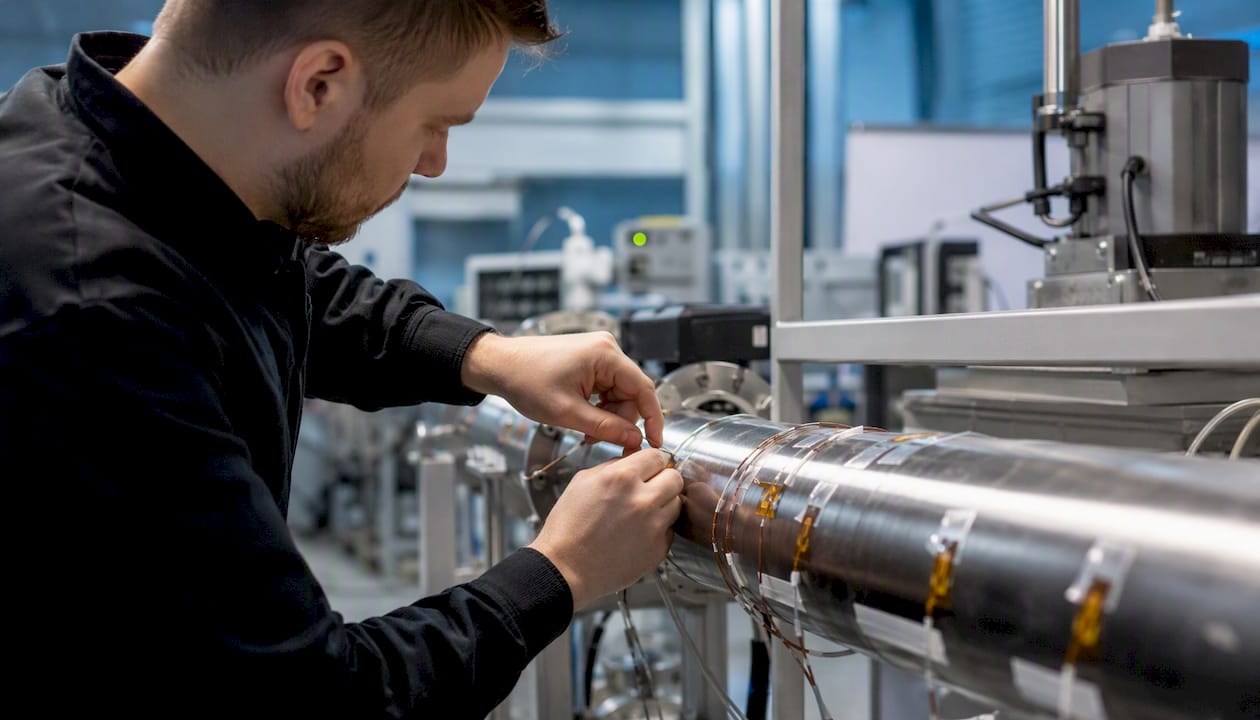 Engineer hands attaching temperature sensors to pipe