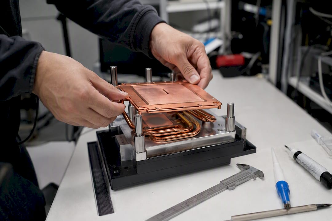 Hands installing heat pipe and vapor chamber