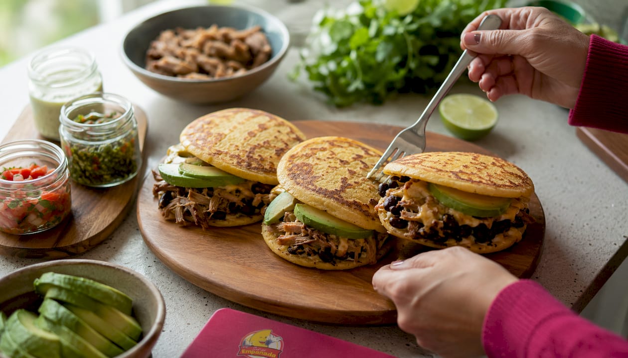 Filled arepas served on wooden plate