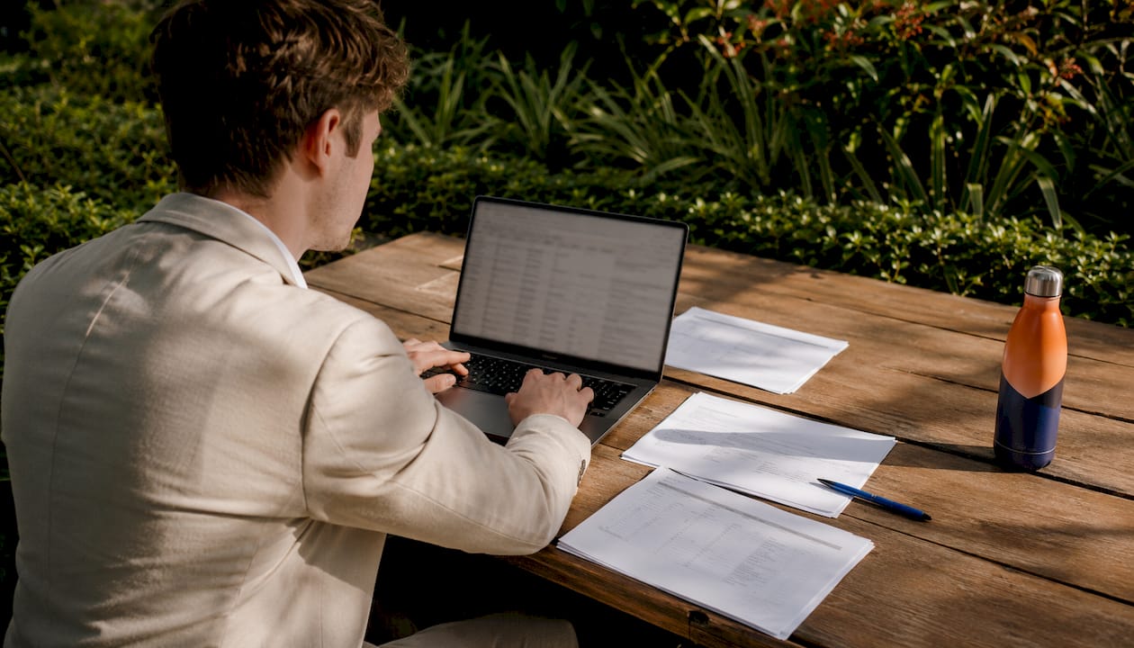 Hands typing vendor queries in Excel template