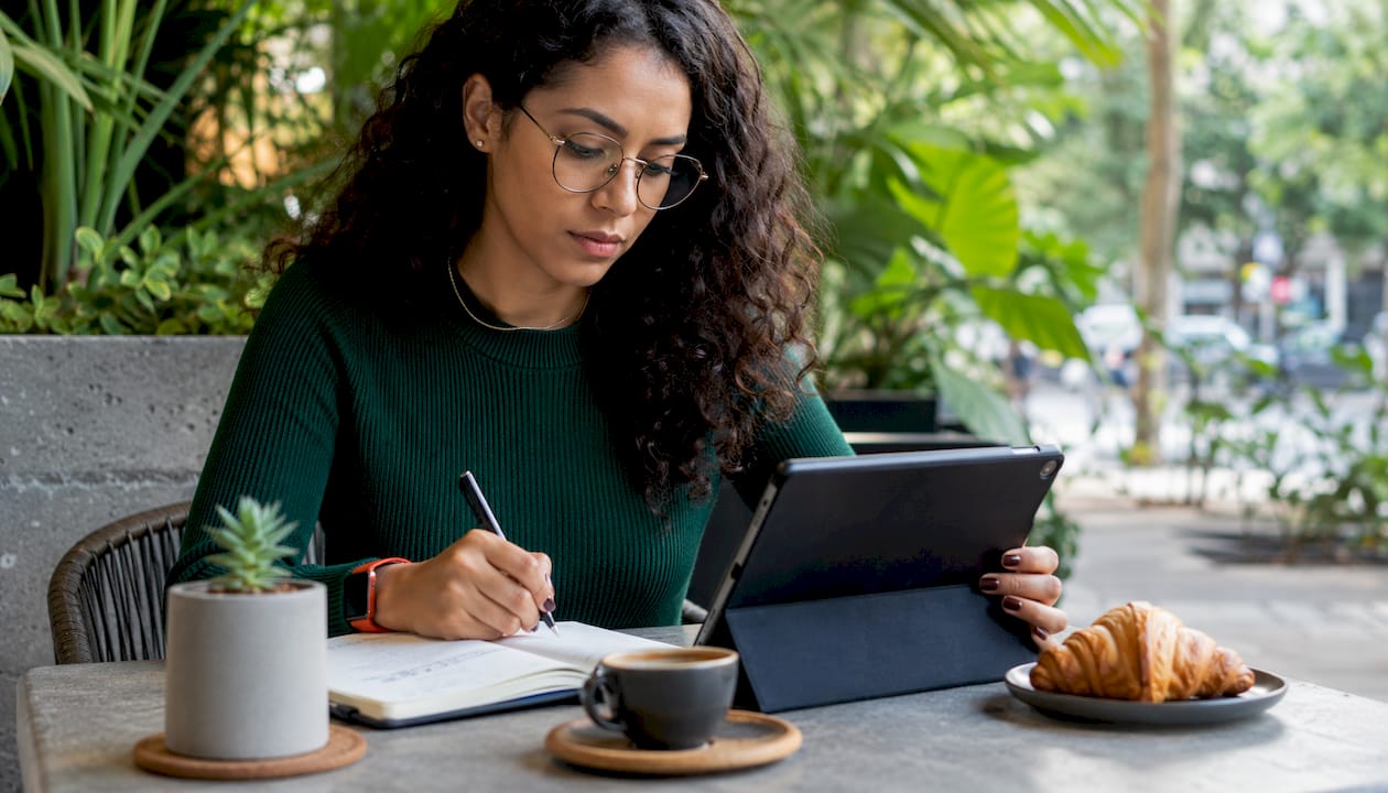 Woman researching buyer needs in café setting