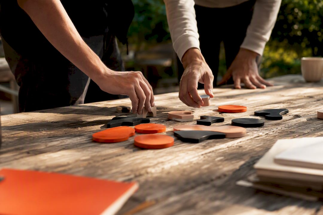 Hands arranging planning blocks on table