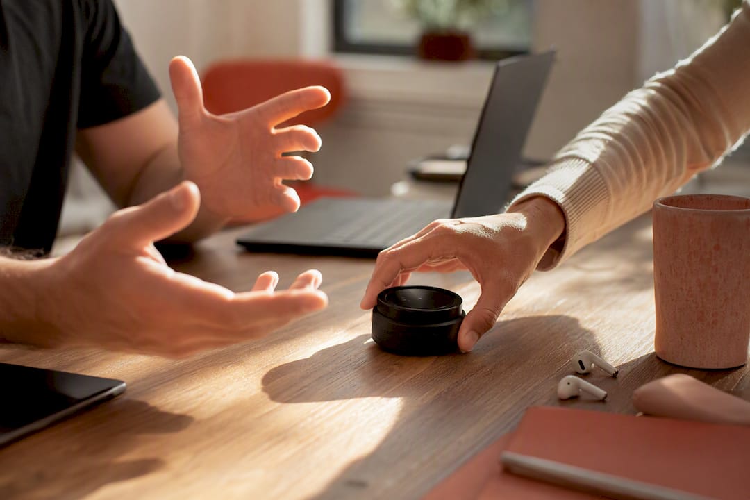 Hands placing timer device on table