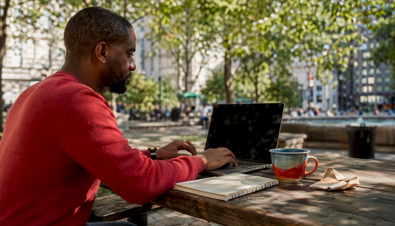 Man managing restaurant digital reputation on laptop