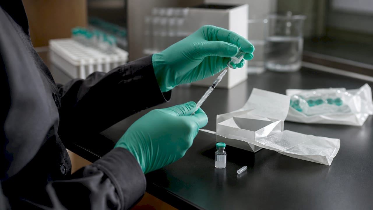 Hands preparing CJC-1295 no DAC injection syringe