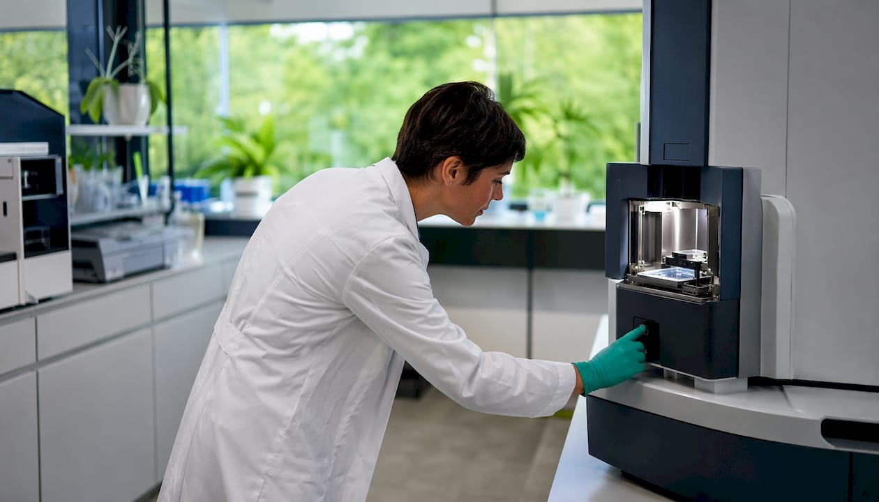 Scientist operating mass spectrometer instrument