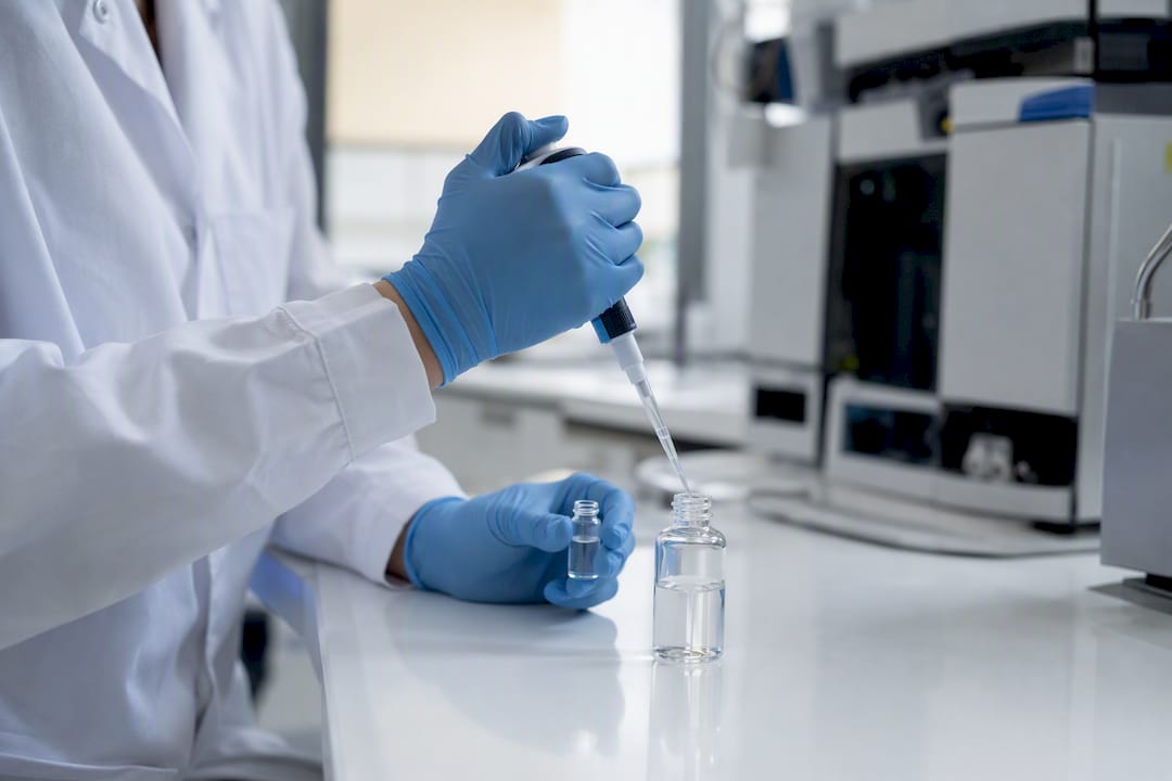 Hands pipetting peptide sample for chromatography