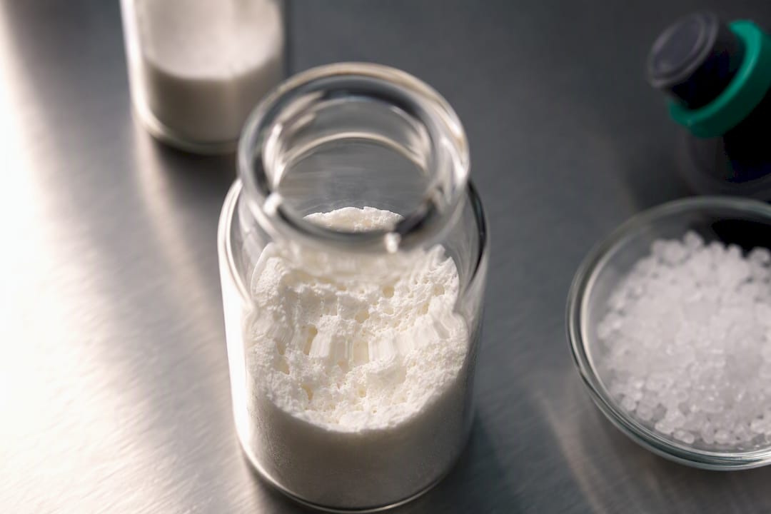 Partially collapsed lyophilized cake in vial