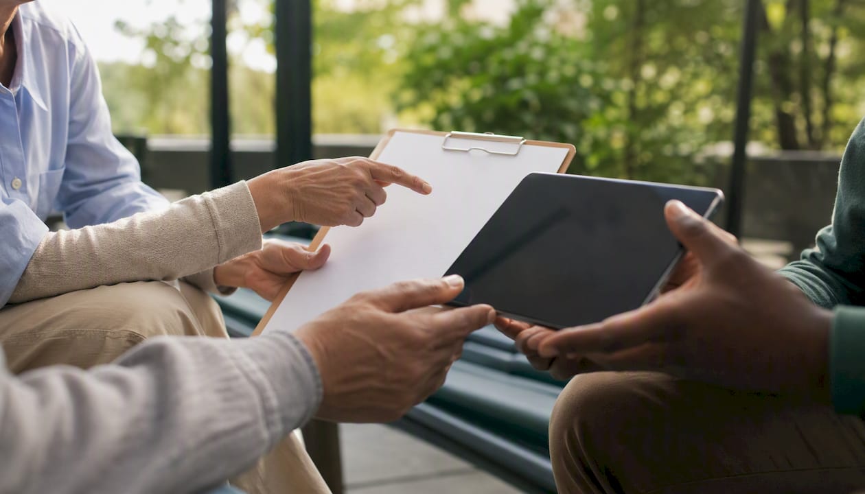Diverse hands exchanging health data documents