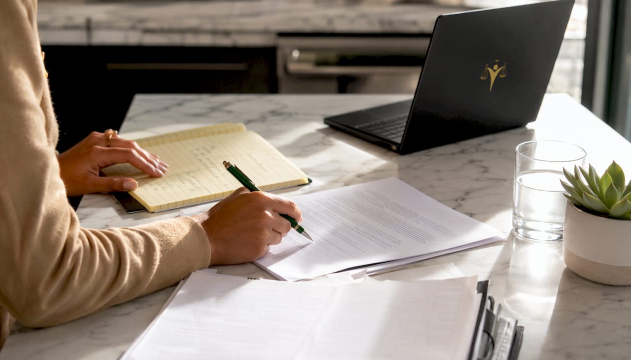 Hands reviewing contested versus uncontested divorce paperwork