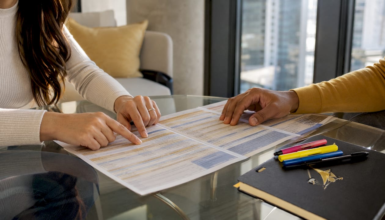 Hands pointing at chart comparing property laws