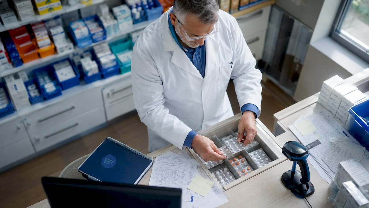 Pharmacist handling secure medication distribution