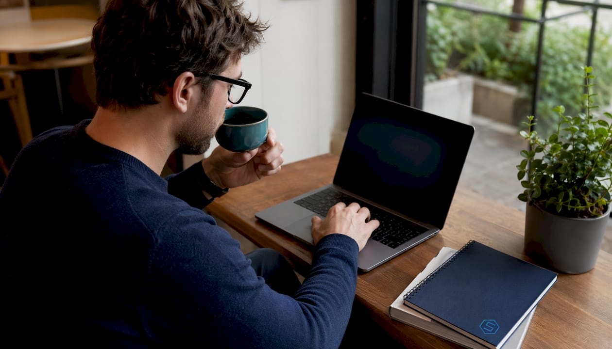 Cybersecurity analyst working on laptop in home office