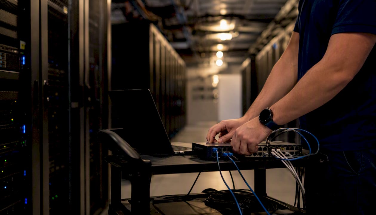 Hands typing commands near Microsoft 365 storage hardware