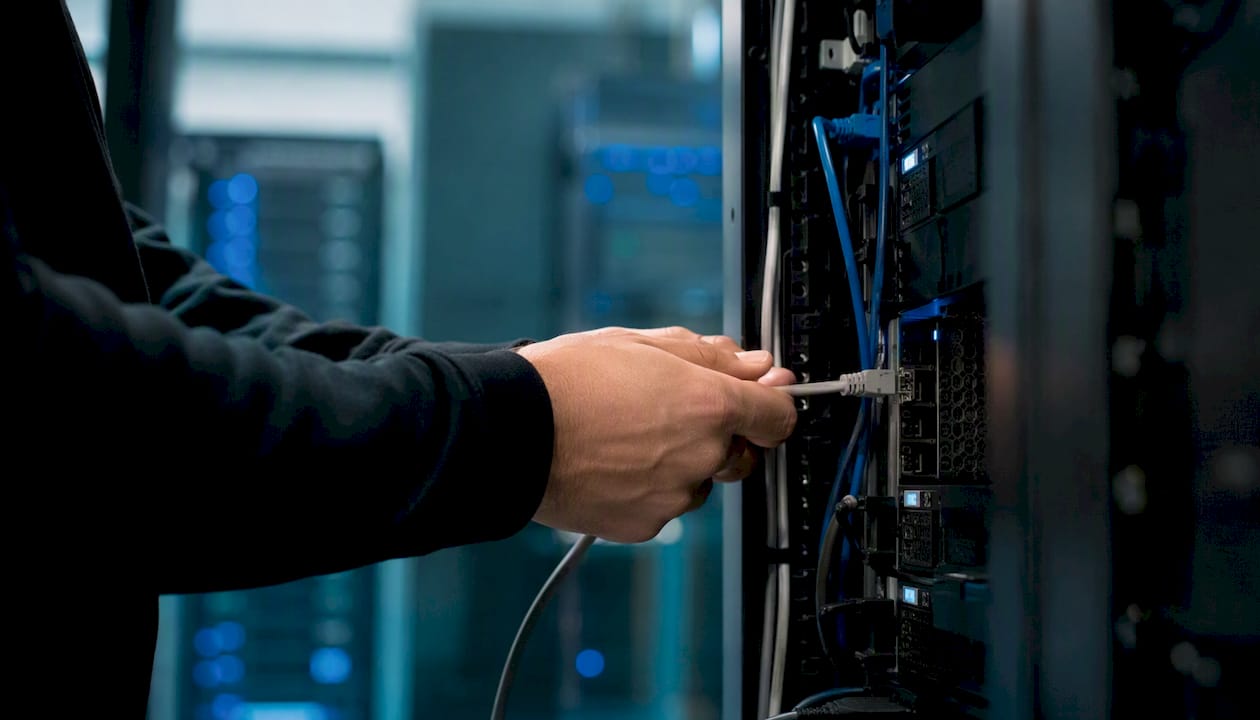 Technician unplugging network cable for endpoint isolation