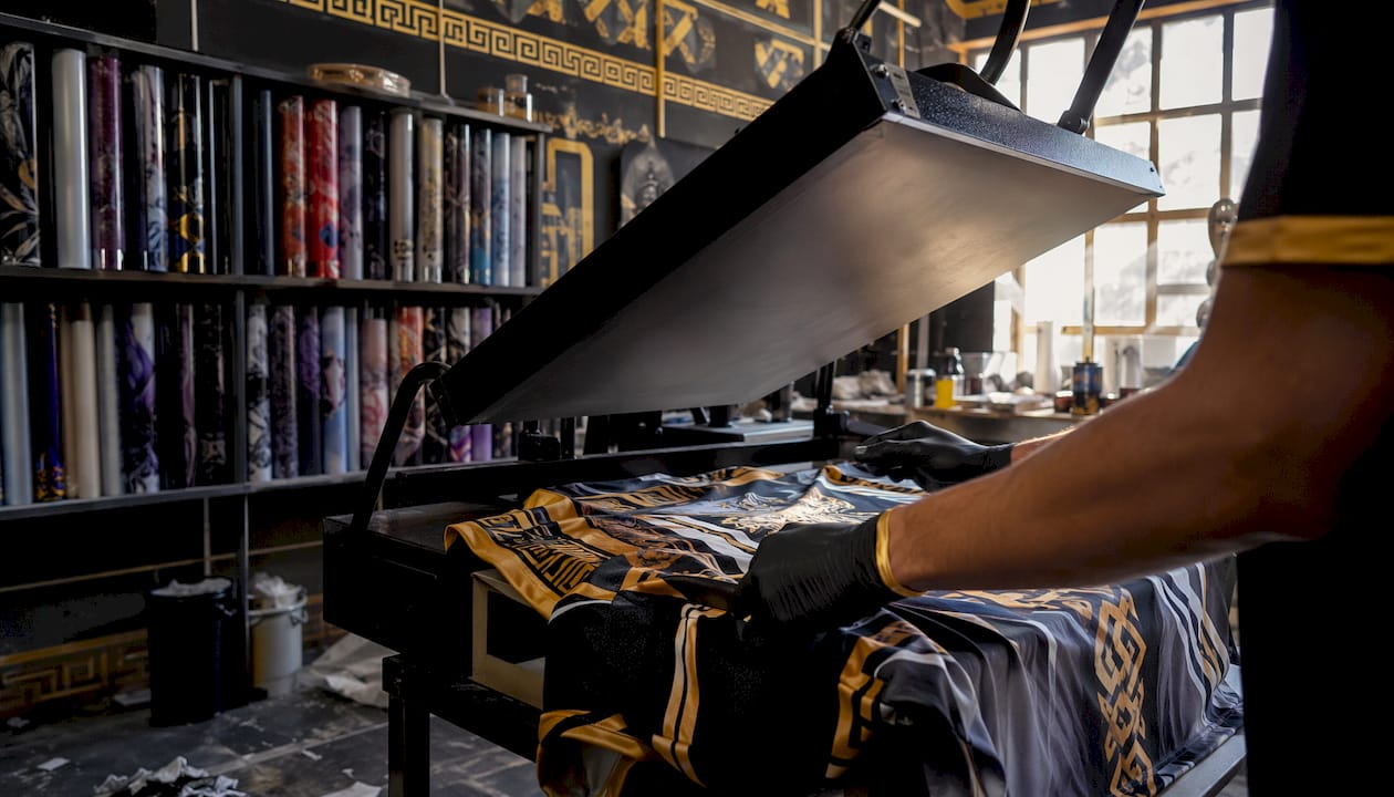 Hands operating polyester sublimation heat press