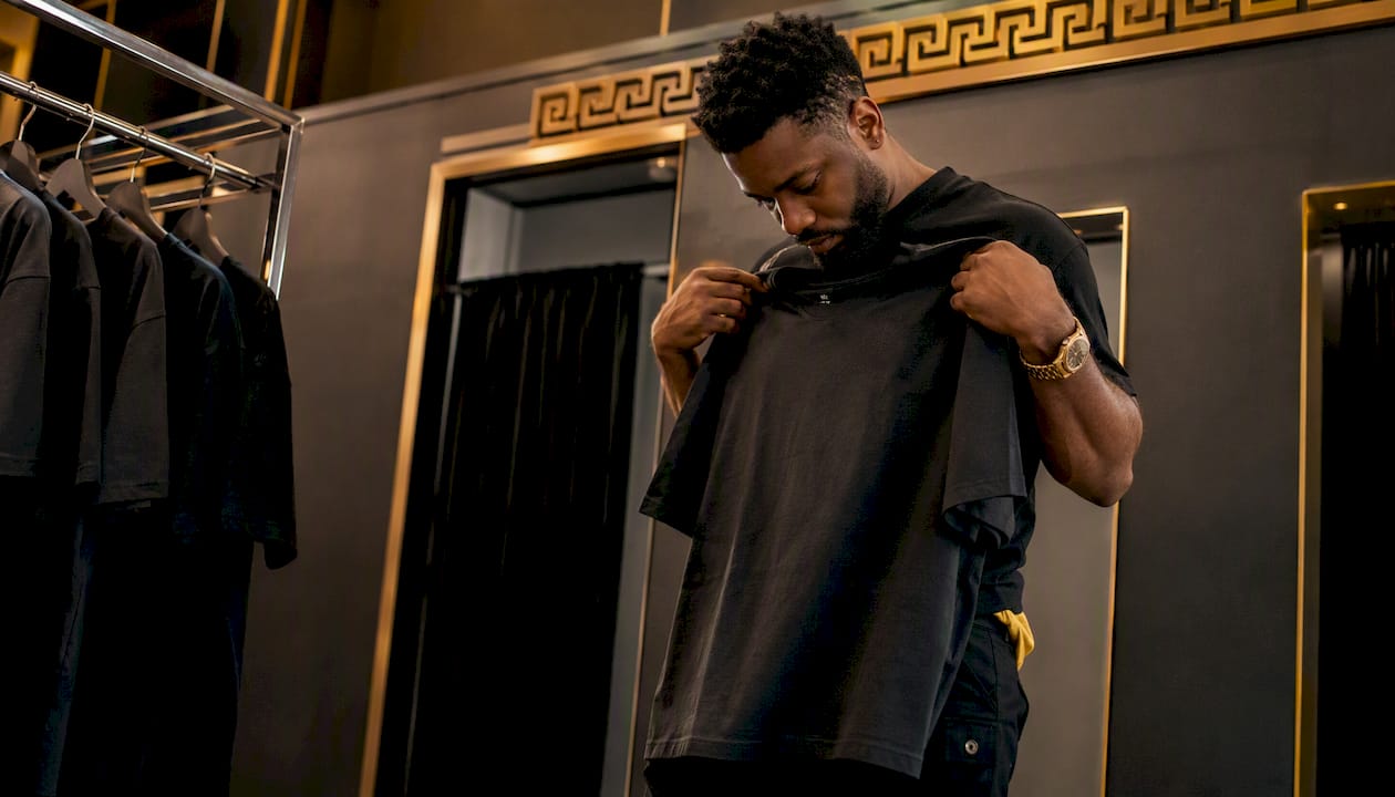 Man evaluating a heavyweight cotton crew neck T-shirt in store