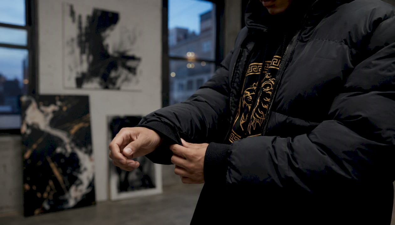 Close-up of cuffed puffer sleeve over hoodie