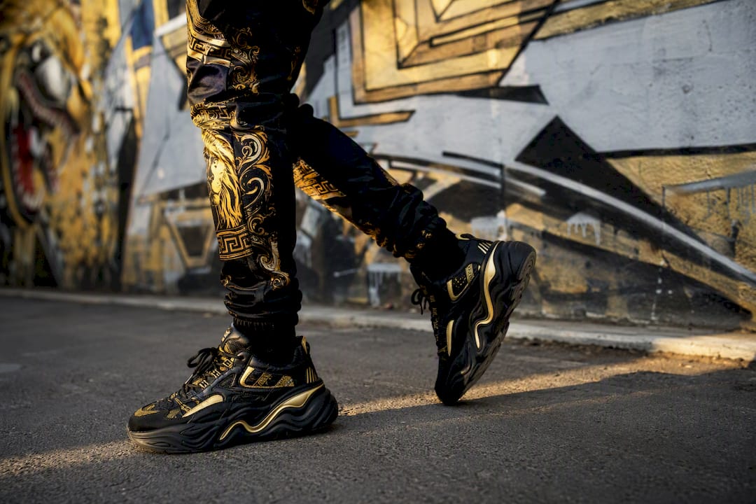 Chunky streetwear sneakers walking on sidewalk