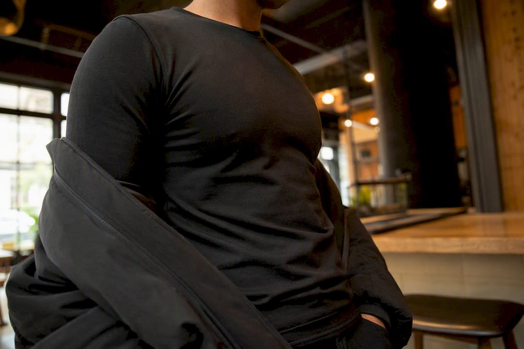 Fitted black base layer fabric close-up