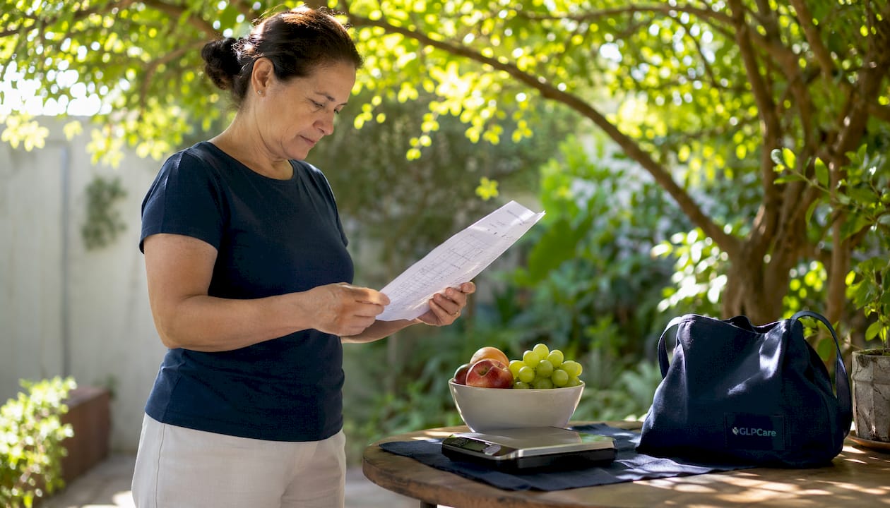 Person reviewing weight loss log at table