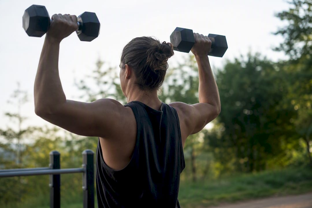 Person lifting dumbbells in gym