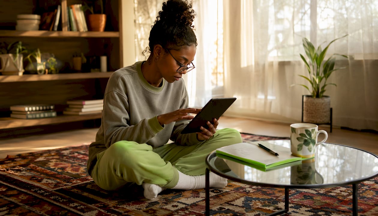 Woman using tablet to check NBA AI picks at home