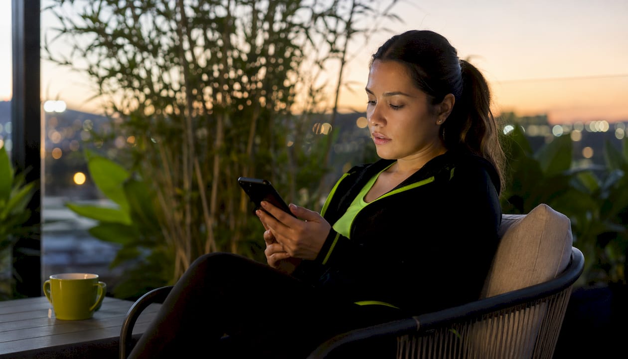 Woman monitoring live AI sports betting odds
