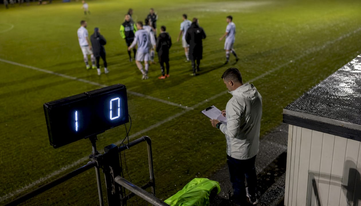 Nighttime soccer scoreboard showing halftime score