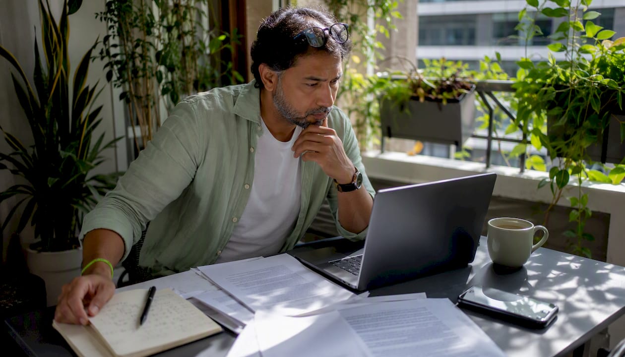 Man reviewing sports betting laws on laptop
