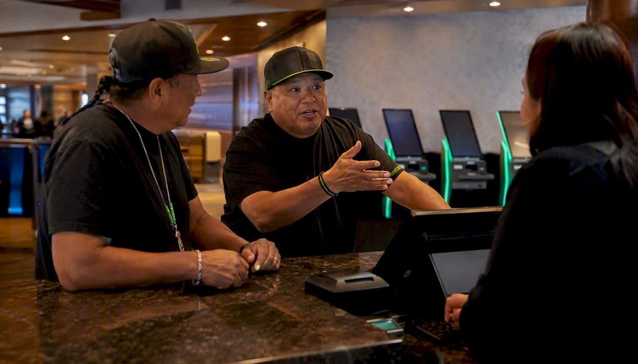 Men placing bets at tribal sportsbook counter
