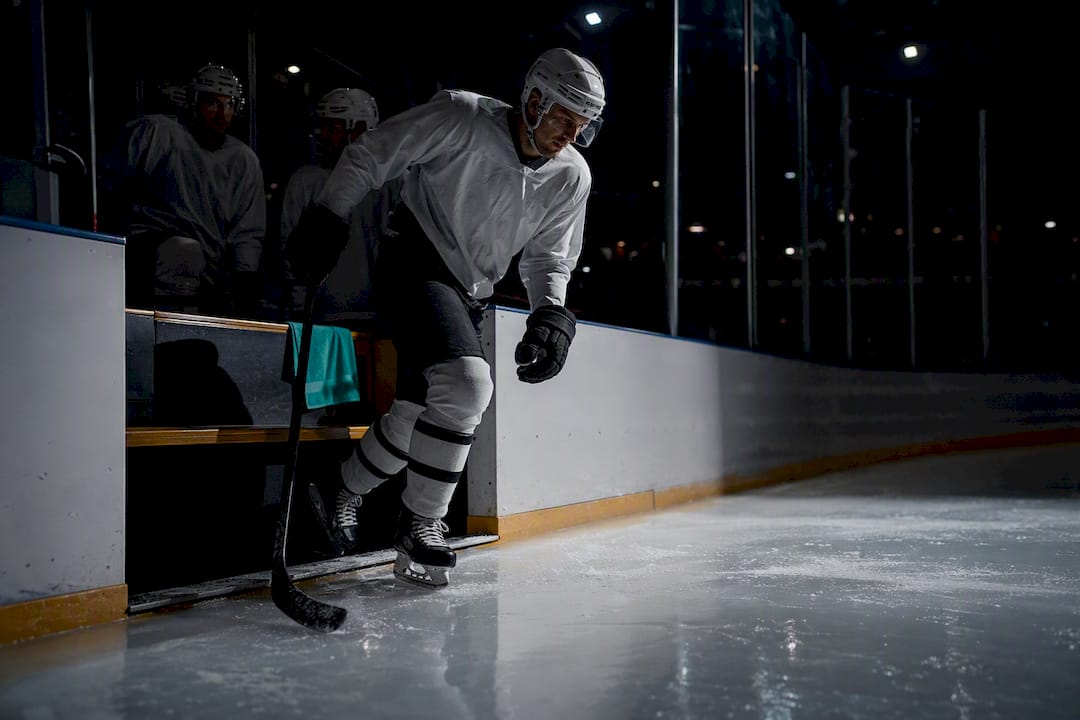 Hockey players entering an arena for a night game
