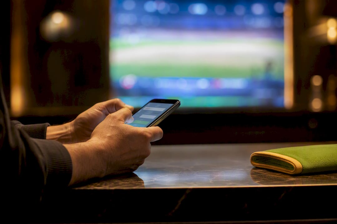 Bettor comparing sports betting lines