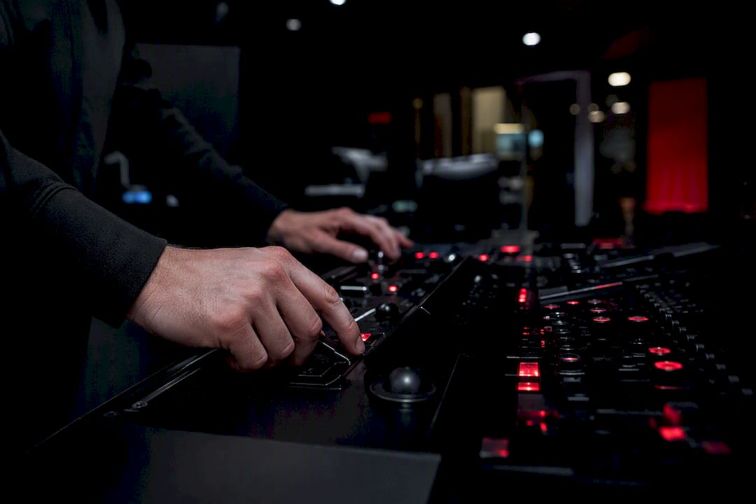 Hands engaging hardware security token at control console