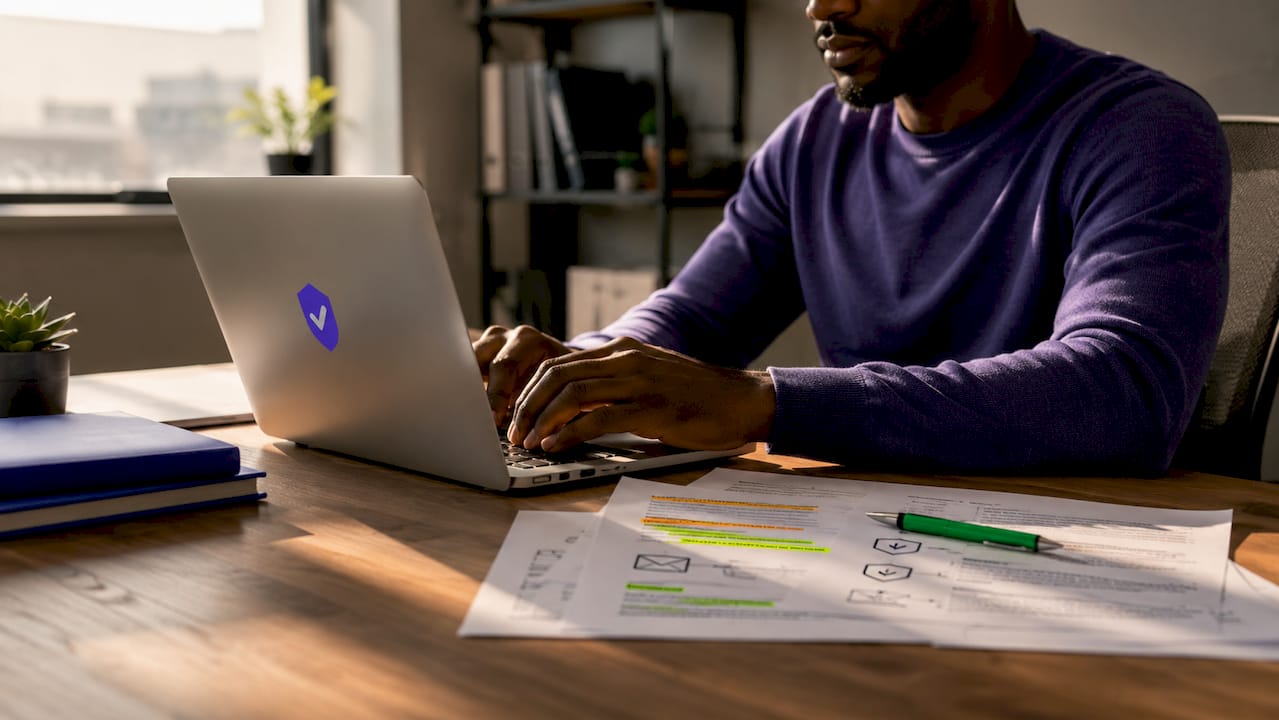 Hands typing near email security documents