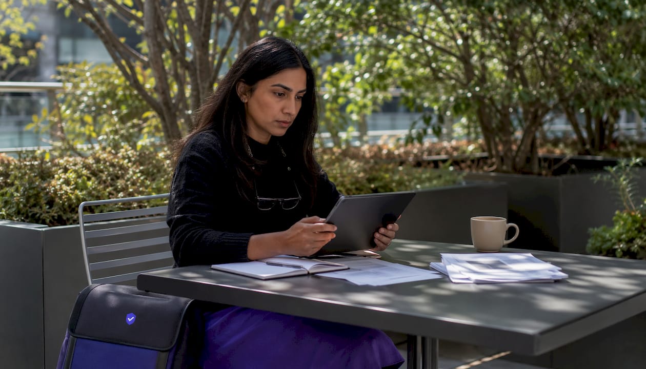 Woman reviewing domain reputation reports on tablet