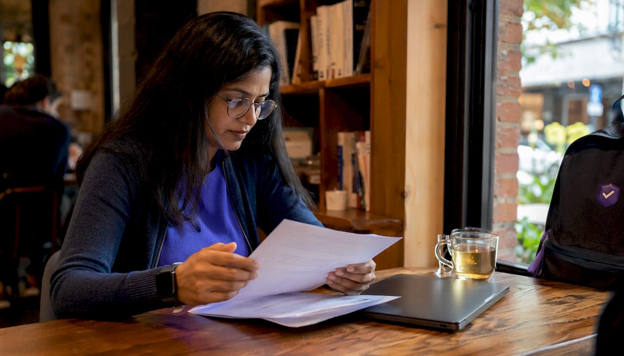 Woman analyzing email headers at home office