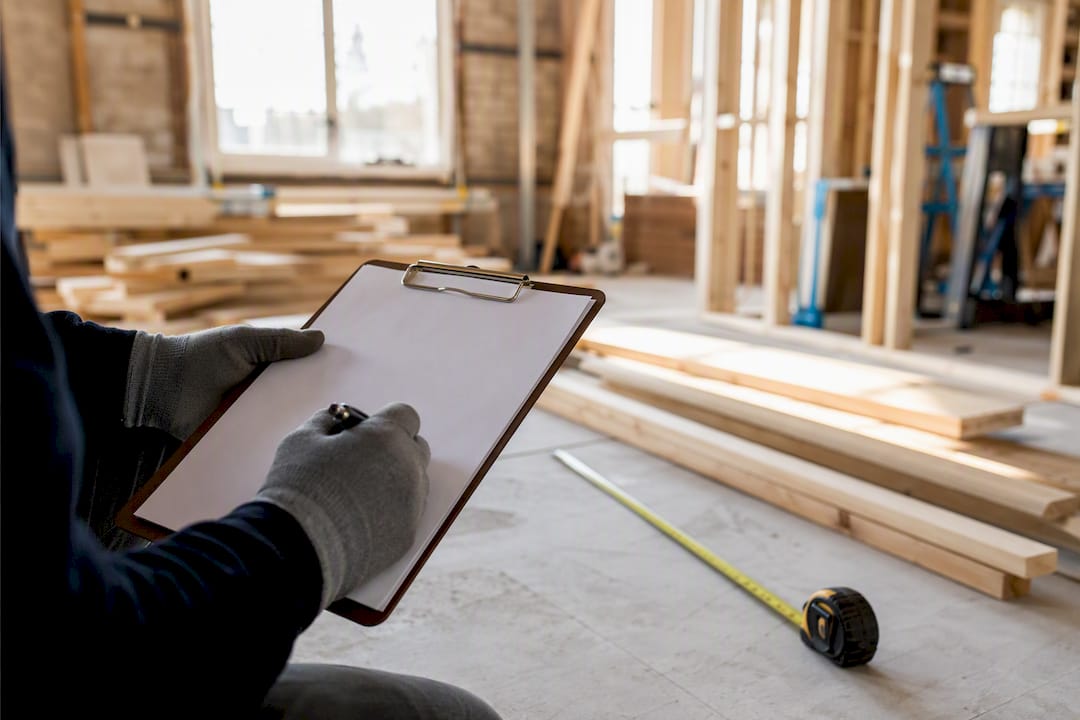 Hands holding blank paperwork at renovation site