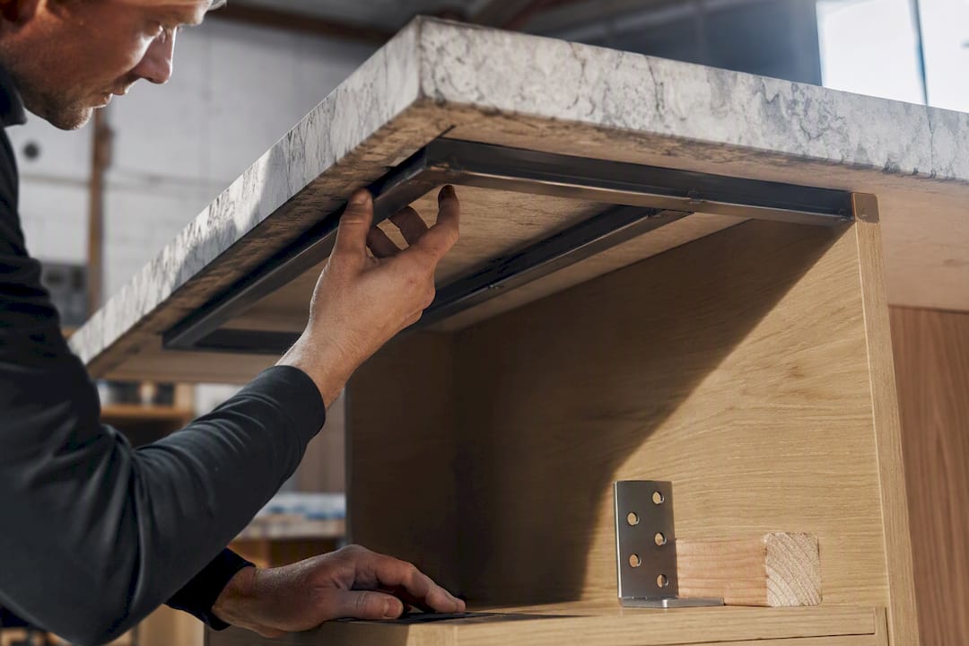 Steel support beneath stone benchtop overhang