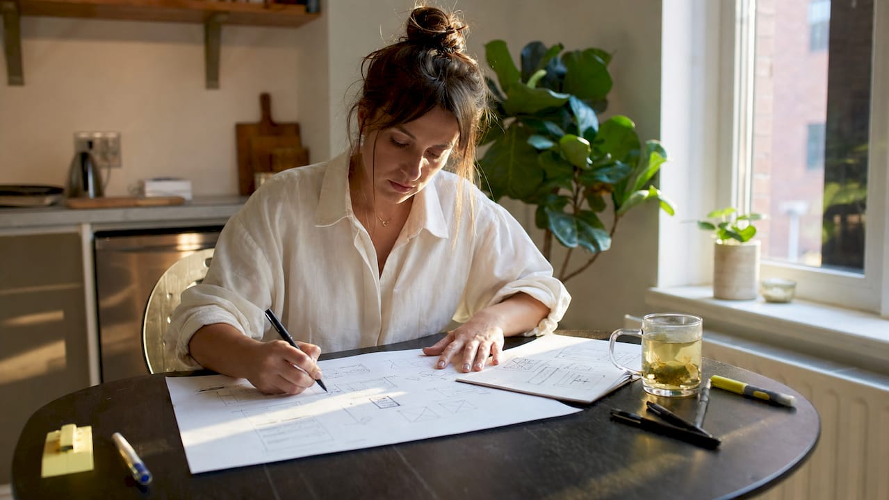 Startup founder sketching digital product wireframes