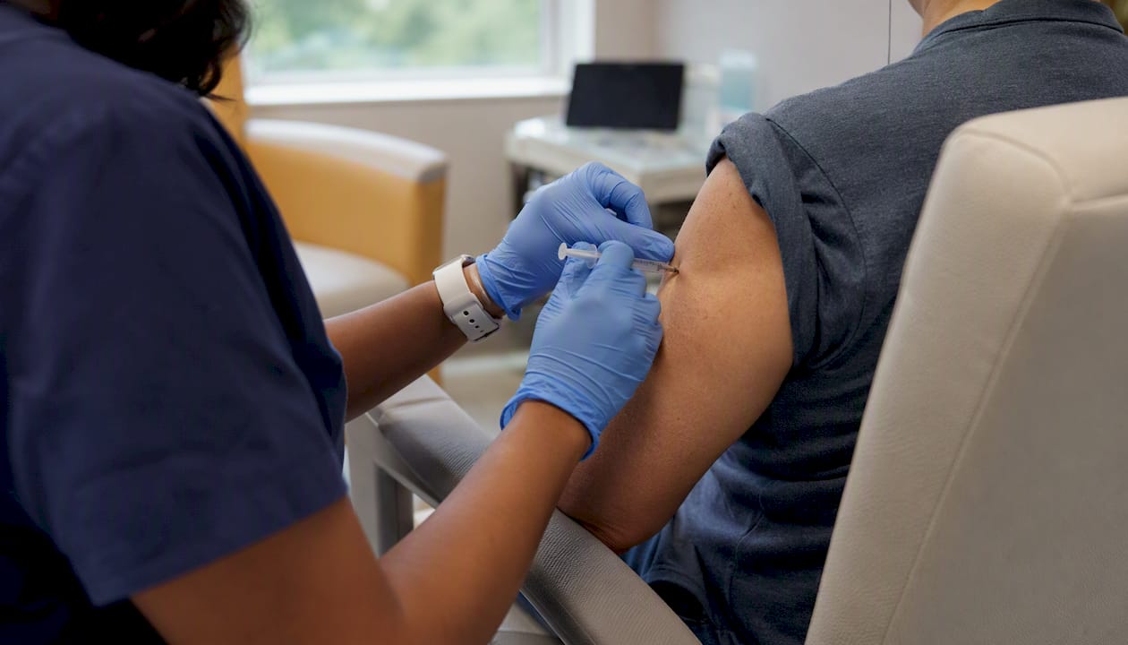 Nurse injecting clinical trial patient