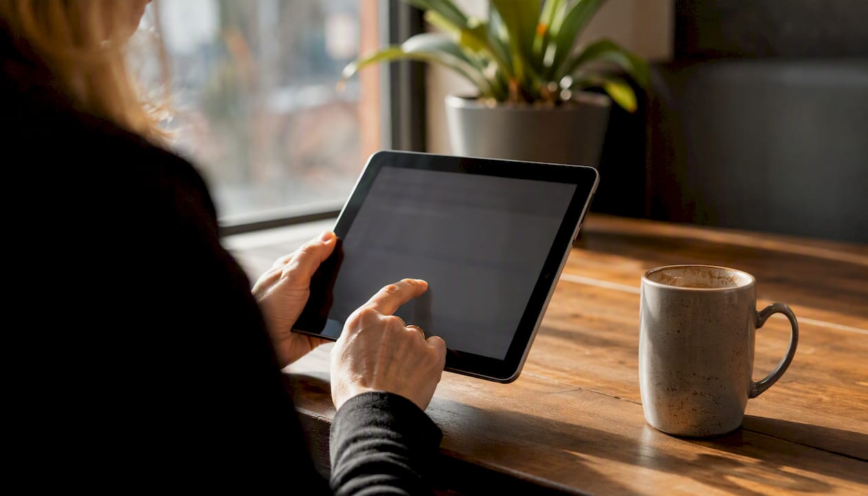 Hands typing corporate email on laptop keyboard