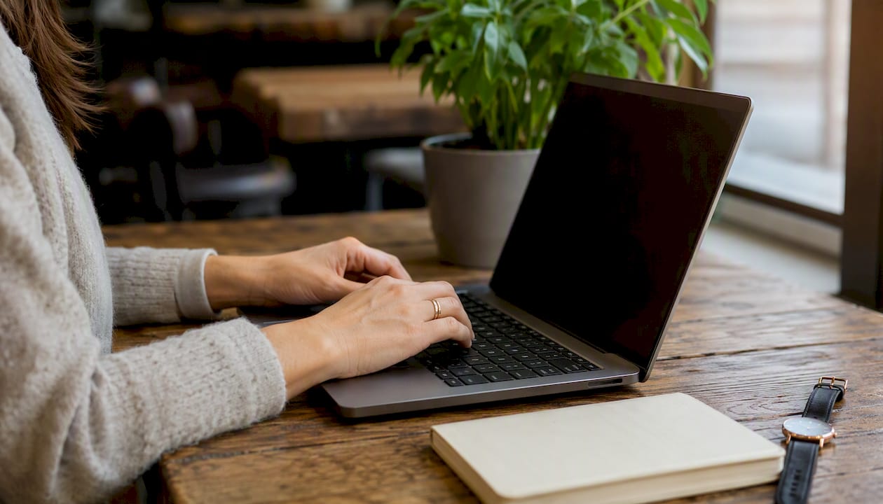 Hands typing on laptop for volunteer grants