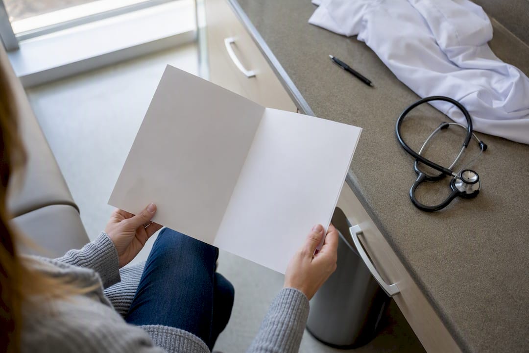 Patient hands turning survivorship care plan document