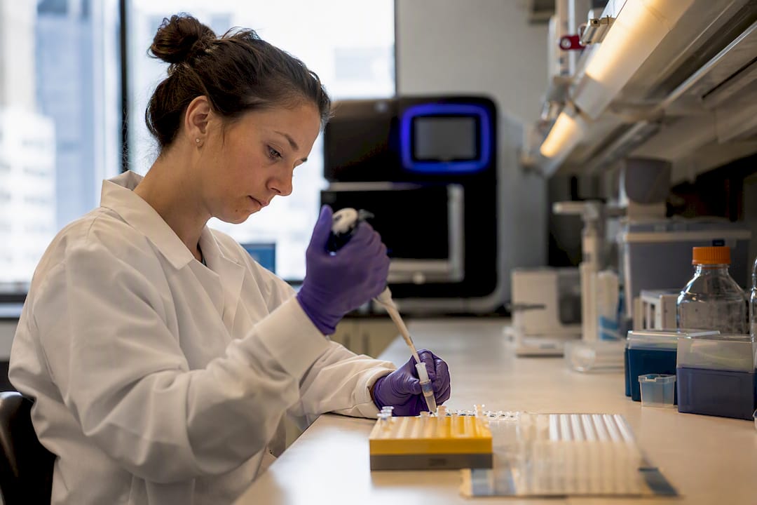 Scientist pipetting DNA sequencing samples