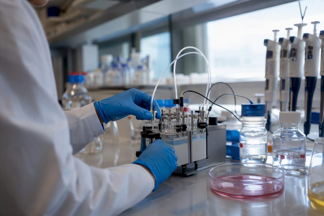 Scientist hands adjusting modular therapy instrument in lab
