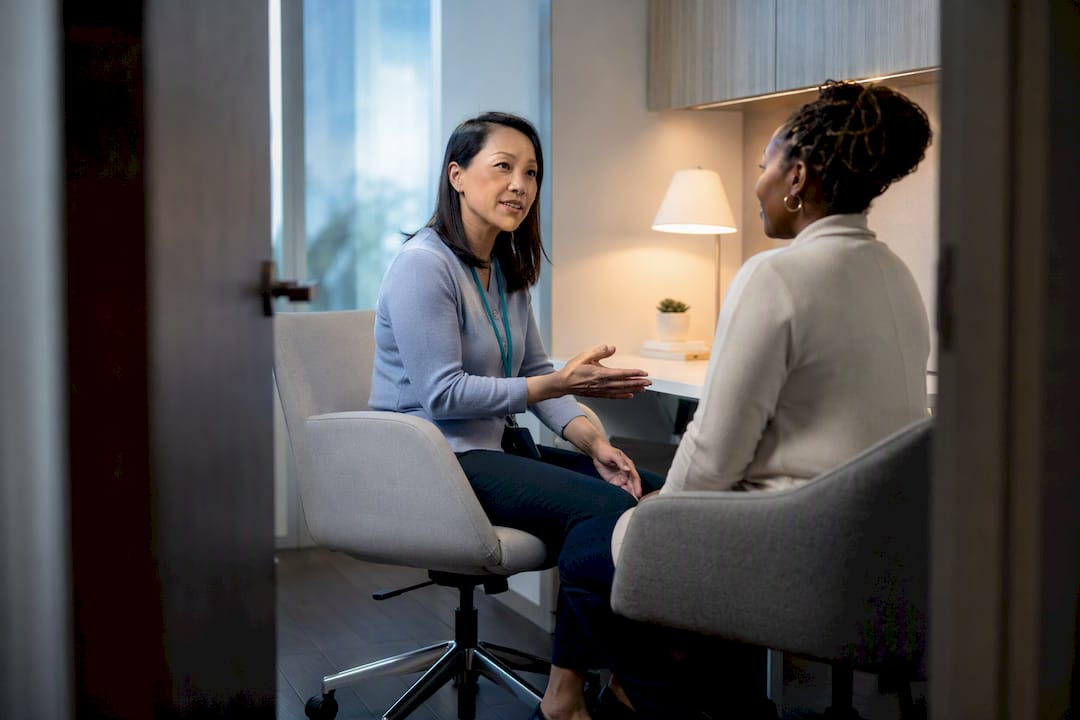Coordinator discussing clinical trial enrollment with patient